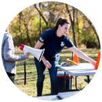 Woman assisting others outdoors, symbolizing the natural high of helping, service, and connection.