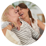 People laughing together under bright light, symbolizing endorphin release and joyful connection.