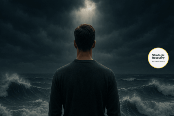 A person standing calmly before stormy ocean waves under dark clouds with light breaking through, symbolizing mastering addiction recovery triggers and relapse prevention.
