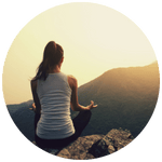Person meditating on a mountain at sunrise, symbolizing inner peace, balance, and the natural high of mindfulness.