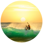 Surfer riding a golden wave at sunset, symbolizing the natural high of flow and freedom.