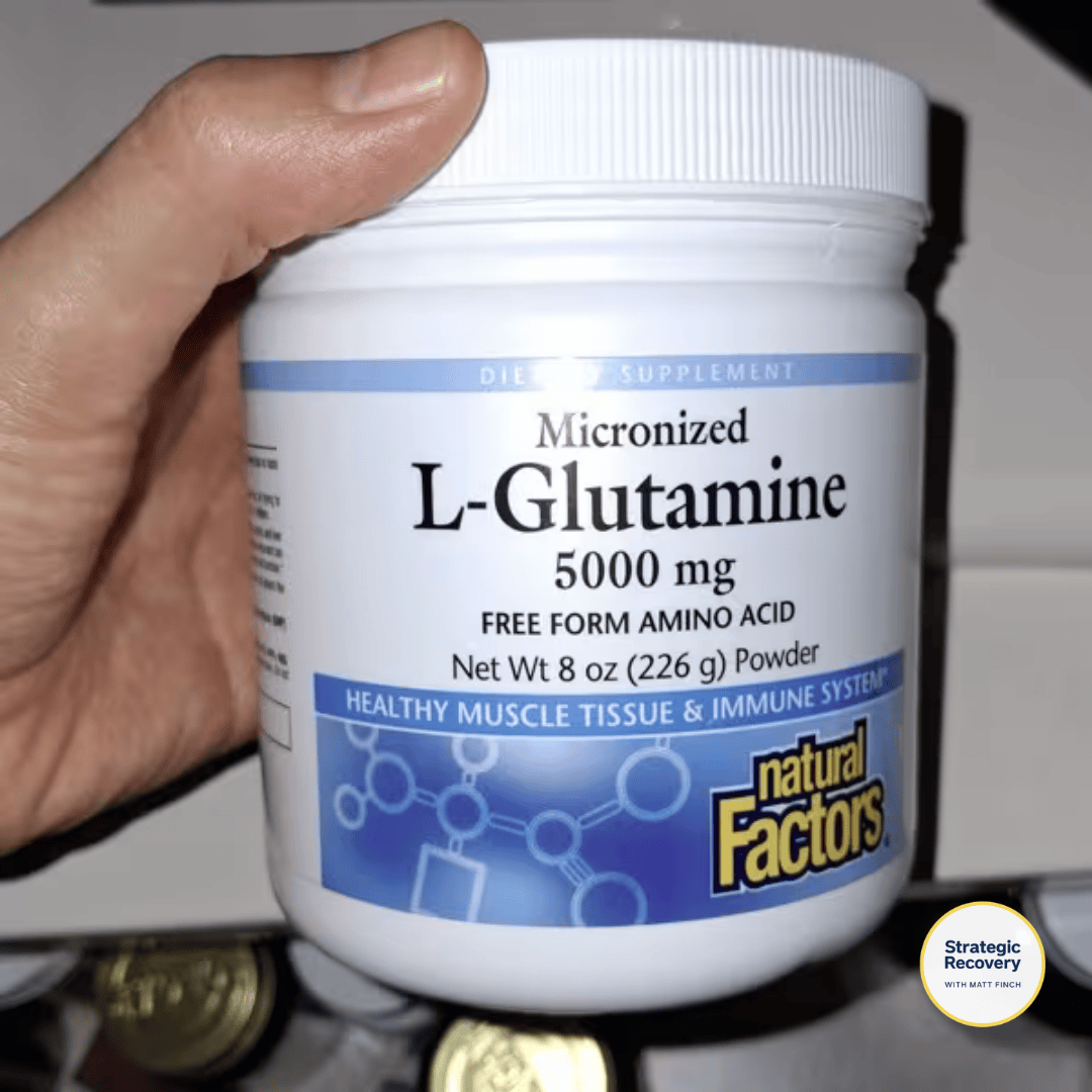 Micronized L-glutamine powder in a clear scoop, ready to mix