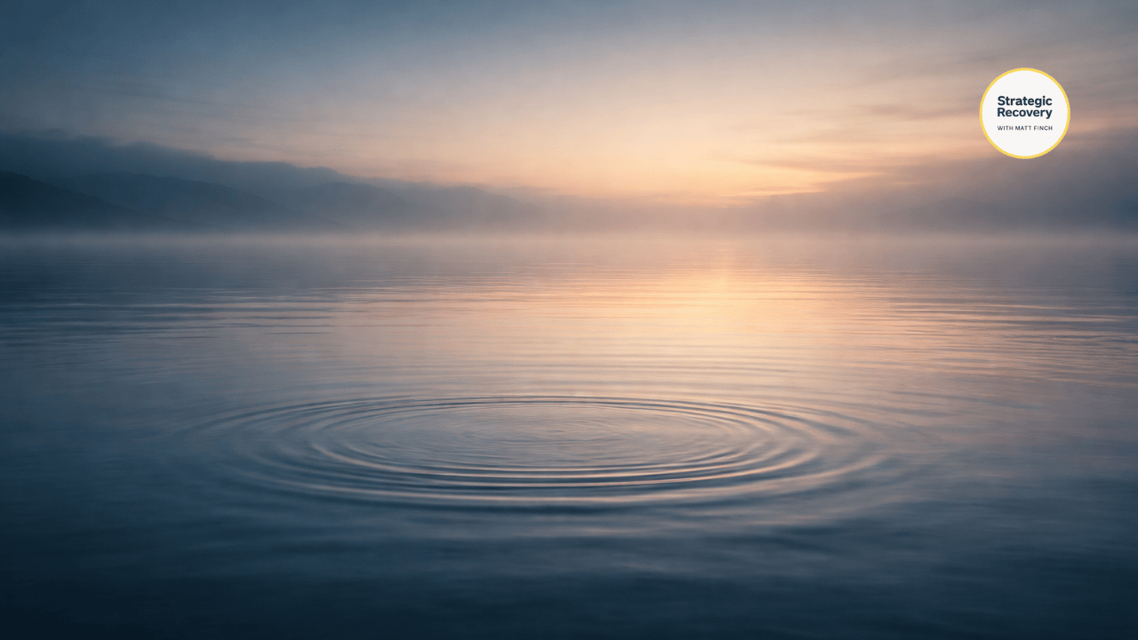 A calm still body of water with soft ripples dissolving into the surface, illuminated by gentle blue and warm gold light, symbolizing nervous system integration and deep calm.
